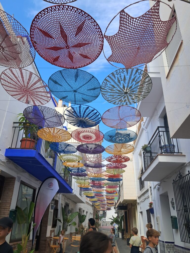 Colourful hanging umbrellas over walking street