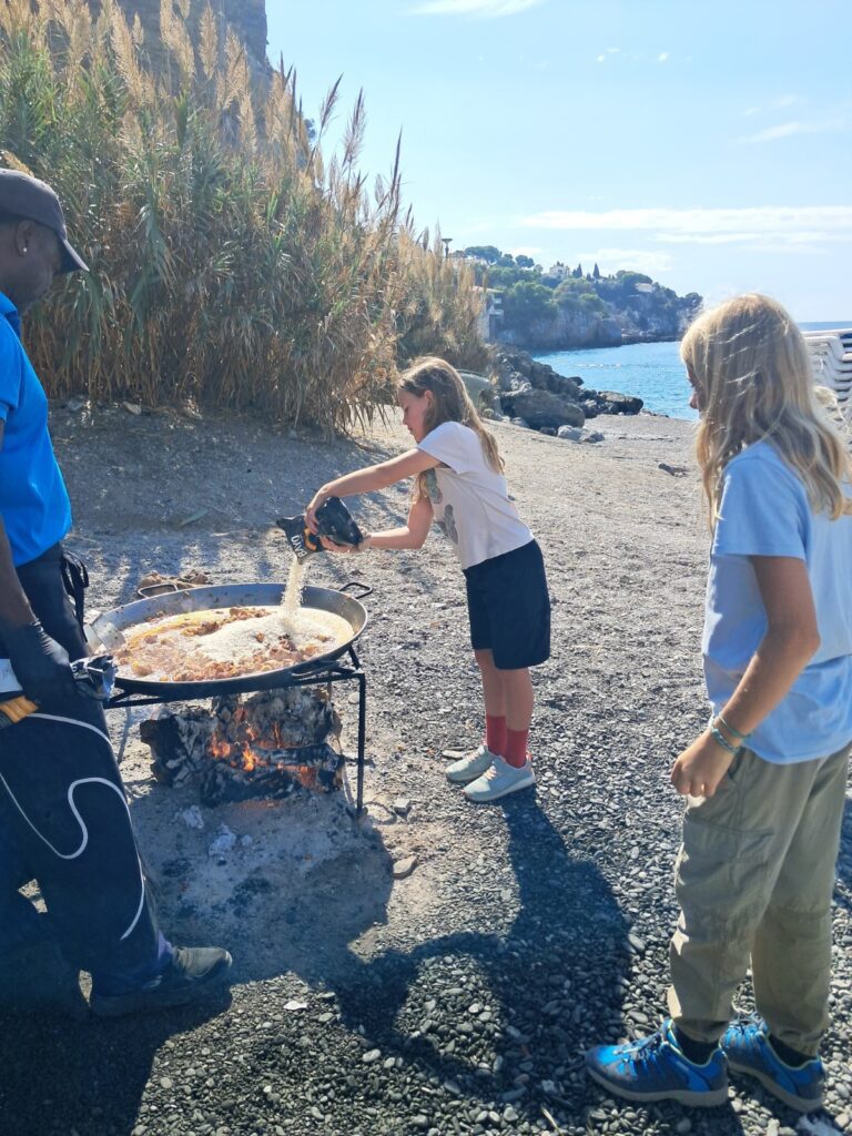 Kids making paella on beach