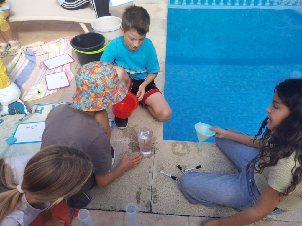 Young students learning measurements with water