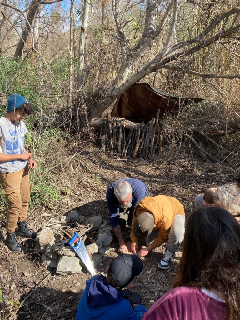 students learning to build fire